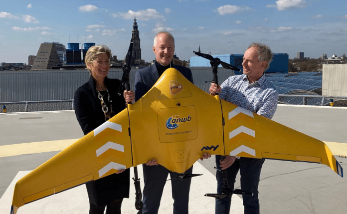 Medische drone - 3 personen poseren op de heliplaats van het UMCG met de medische drone